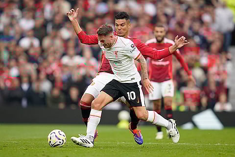 English Premier League 2024-25 Liverpool vs Manchester United: Liverpool's Alexis Mac Allister, centre, challenges for the ball with Manchester United's Casemiro